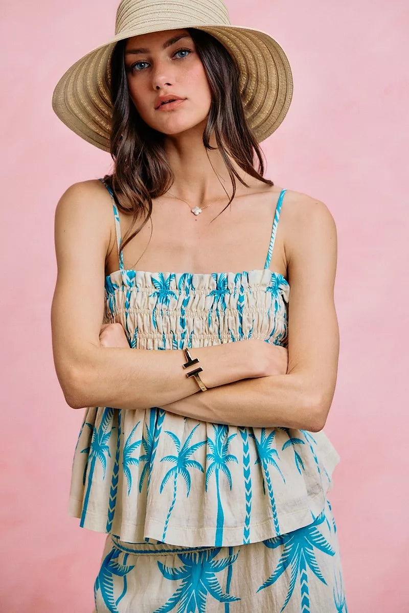 Blue palm-print smocked cami top with adjustable straps and tiered peplum hem