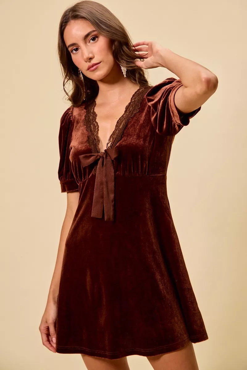 Burgundy velvet mini dress with lace V-neck, bow tie, and short puff sleeves.