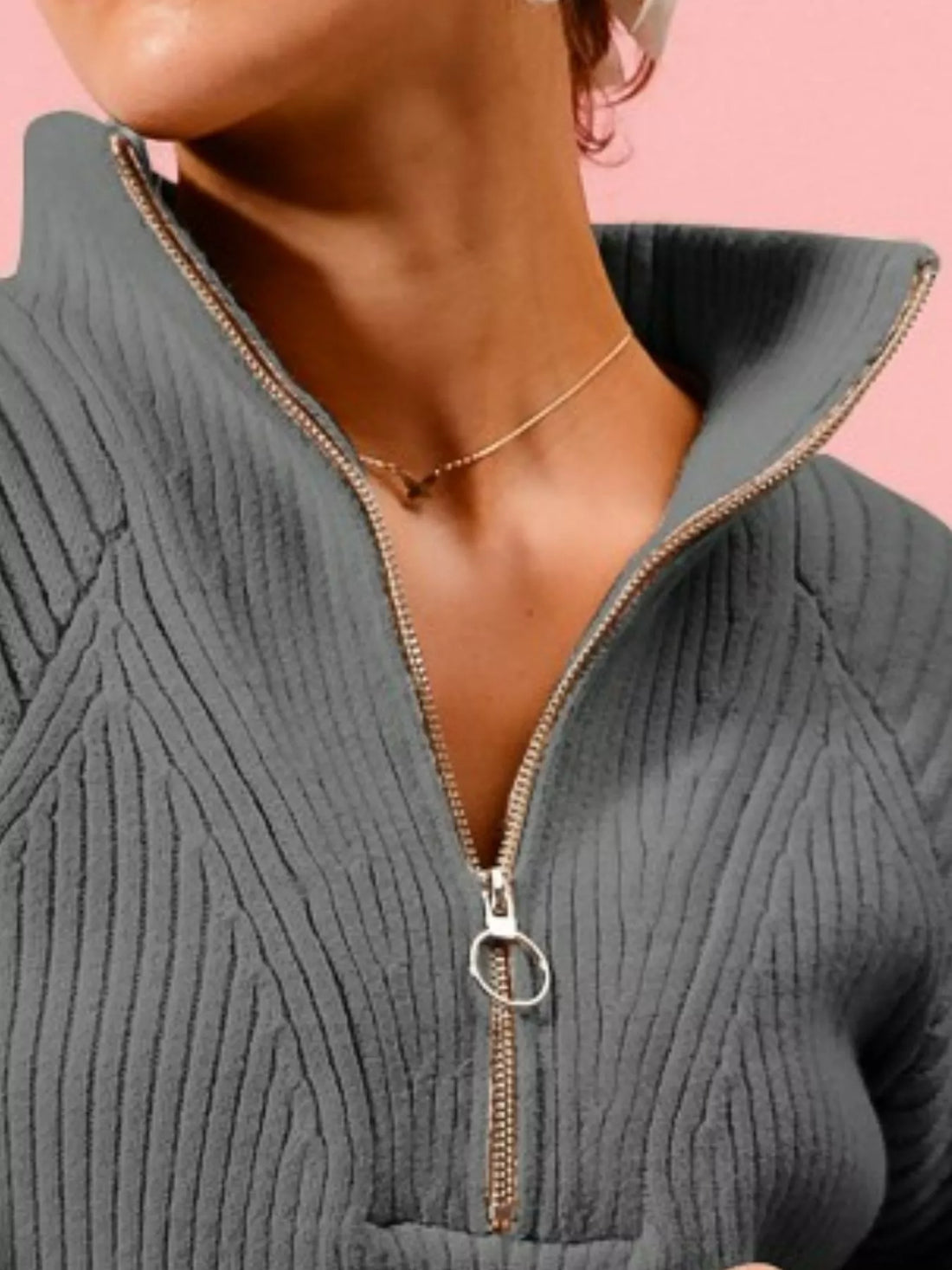 Charcoal half-zip sweater neckline and zipper pull detail