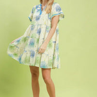 Floral babydoll dress full length with blue contrast trim and tiered skirt, cream