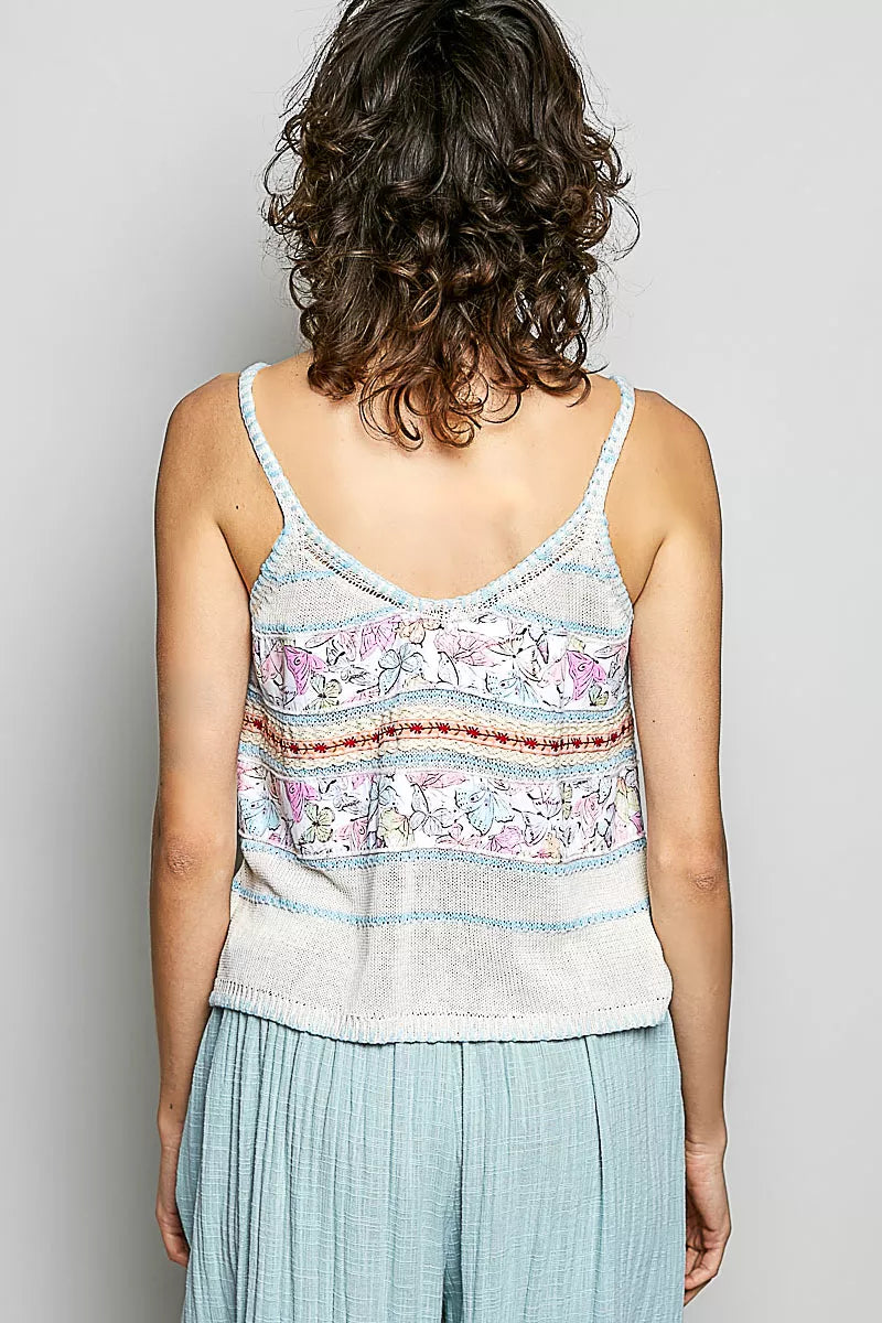Back view of cream and blue printed cami with V-back straps and decorative trim