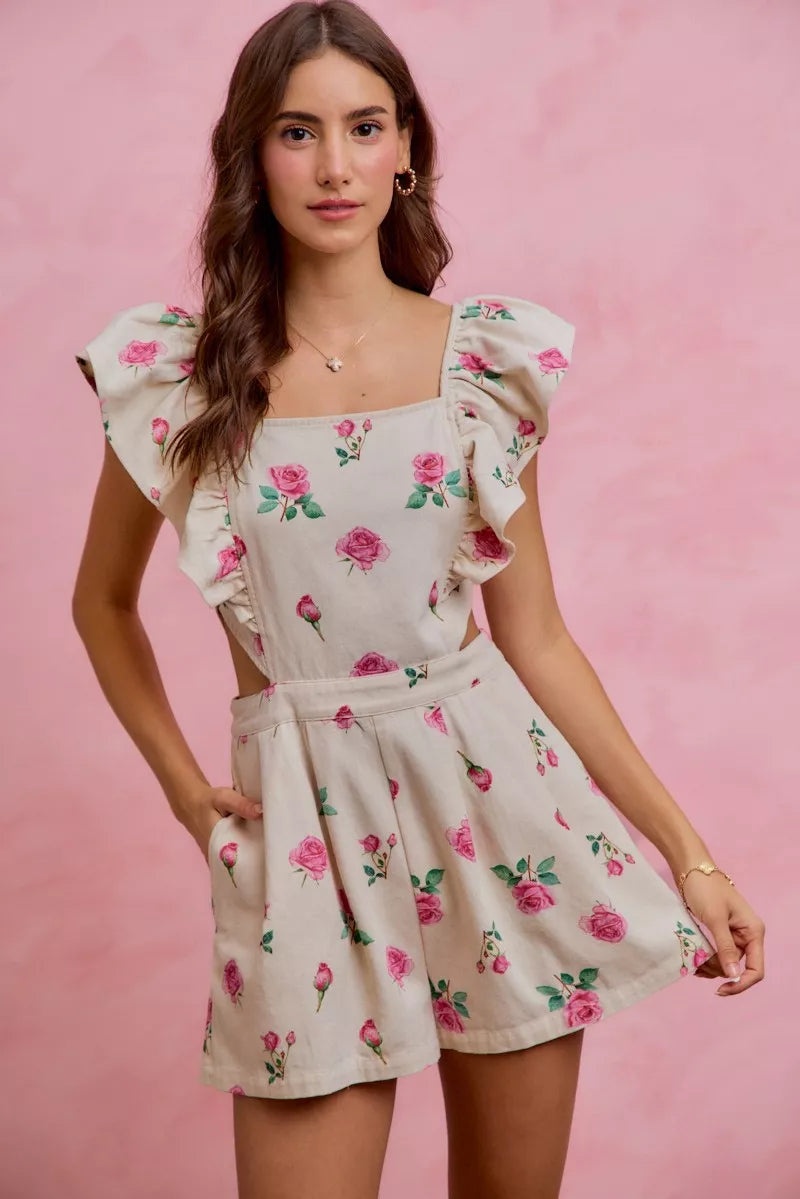 Ivory floral romper with ruffled cap sleeves and gathered waist, pink rose print