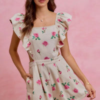 Ivory floral romper with ruffled cap sleeves and gathered waist, pink rose print