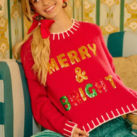 Red Christmas knit sweater with sequin "MERRY" and "BRIGHT" lettering, ribbed neckline.