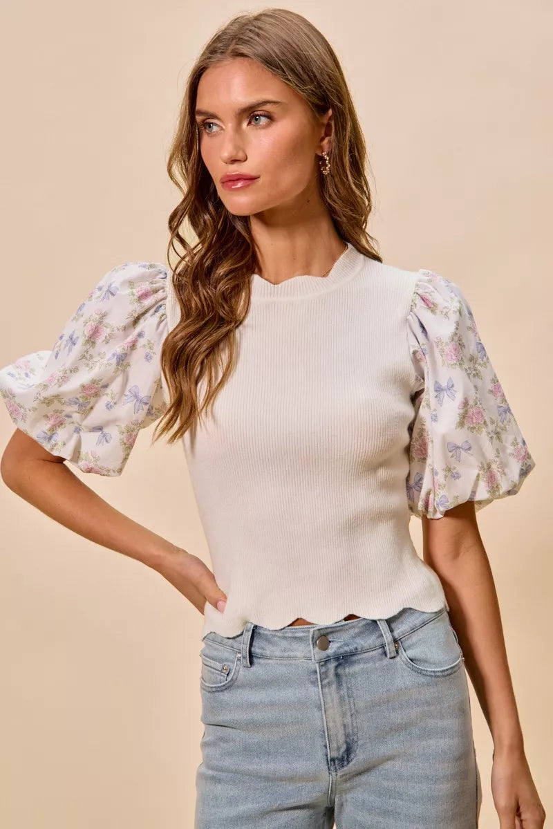 White knit sweater top with short puff floral sleeves and scalloped hemline