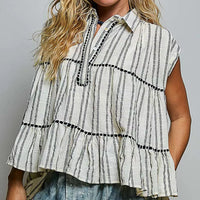 Grey multi-striped sleeveless cotton top with button placket, ruffle tiers, and black trim
