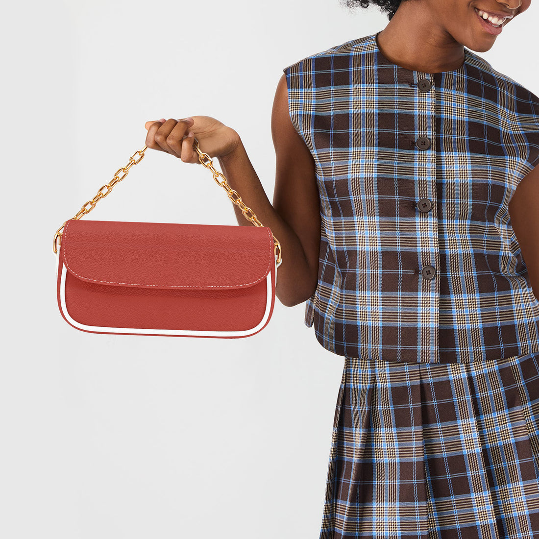 Red leather shoulder bag with gold chain handle and front flap
