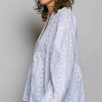 Off-white long-sleeve eyelet blouse with V-neck and gathered, flowy hem