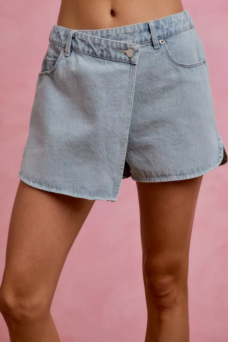 Light blue denim wrap skort with front button, belt loops, and side pockets