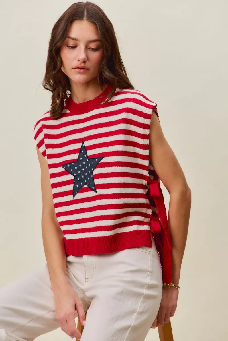 Red and ivory striped sleeveless vest top with navy star patch and ribbed bottom