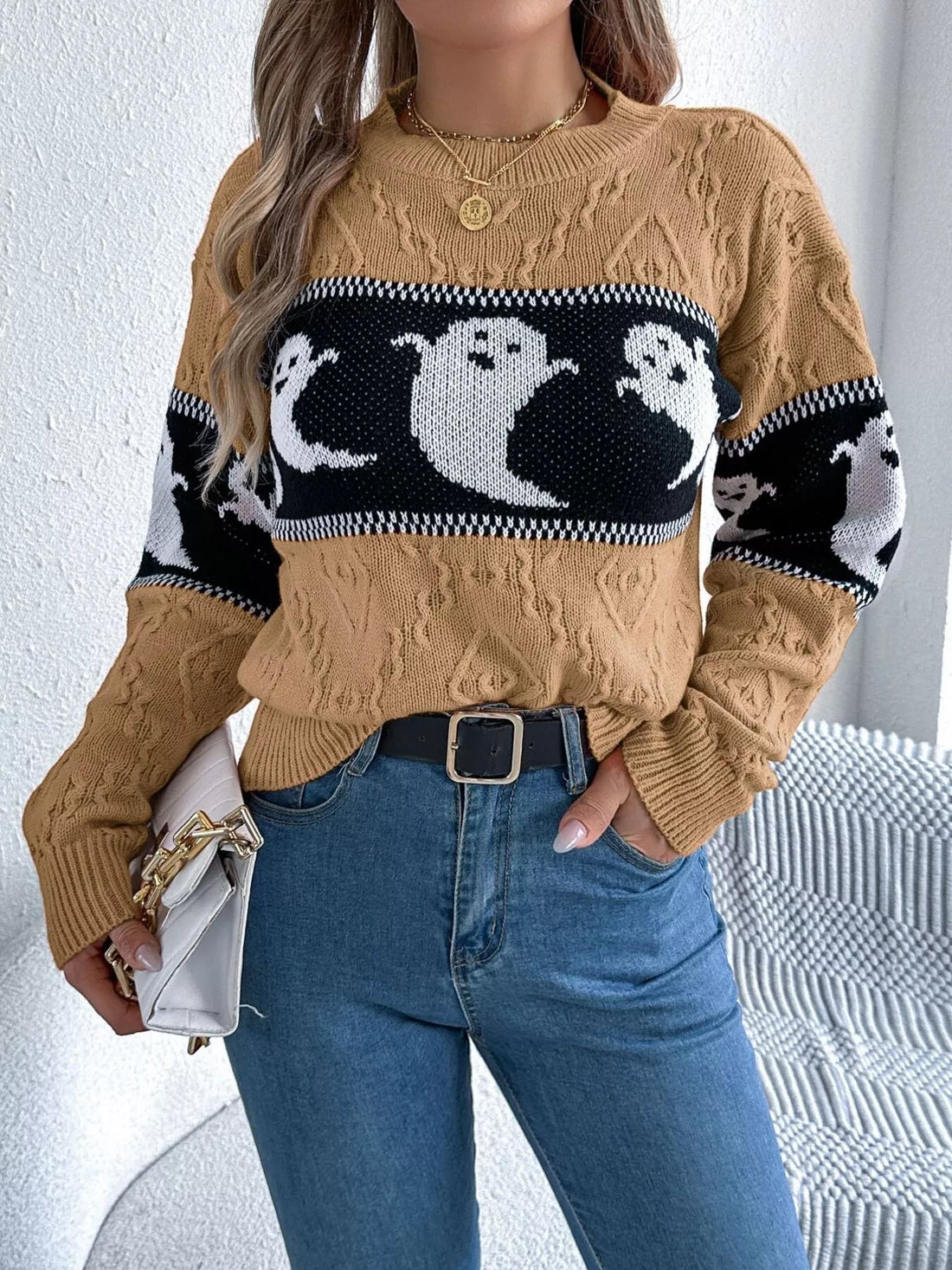 Camel textured sweater with black-and-white ghost motif across front, long sleeves
