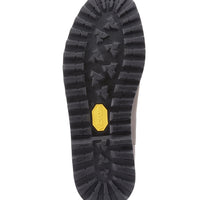 Chelsea boot outsole with deep tread and yellow Vibram badge.