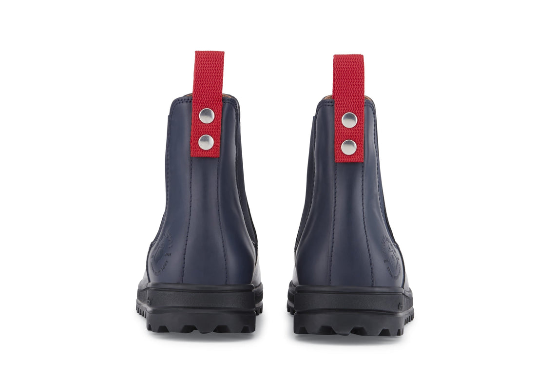 Rear view of navy Chelsea boots with red pull tabs and lugged soles
