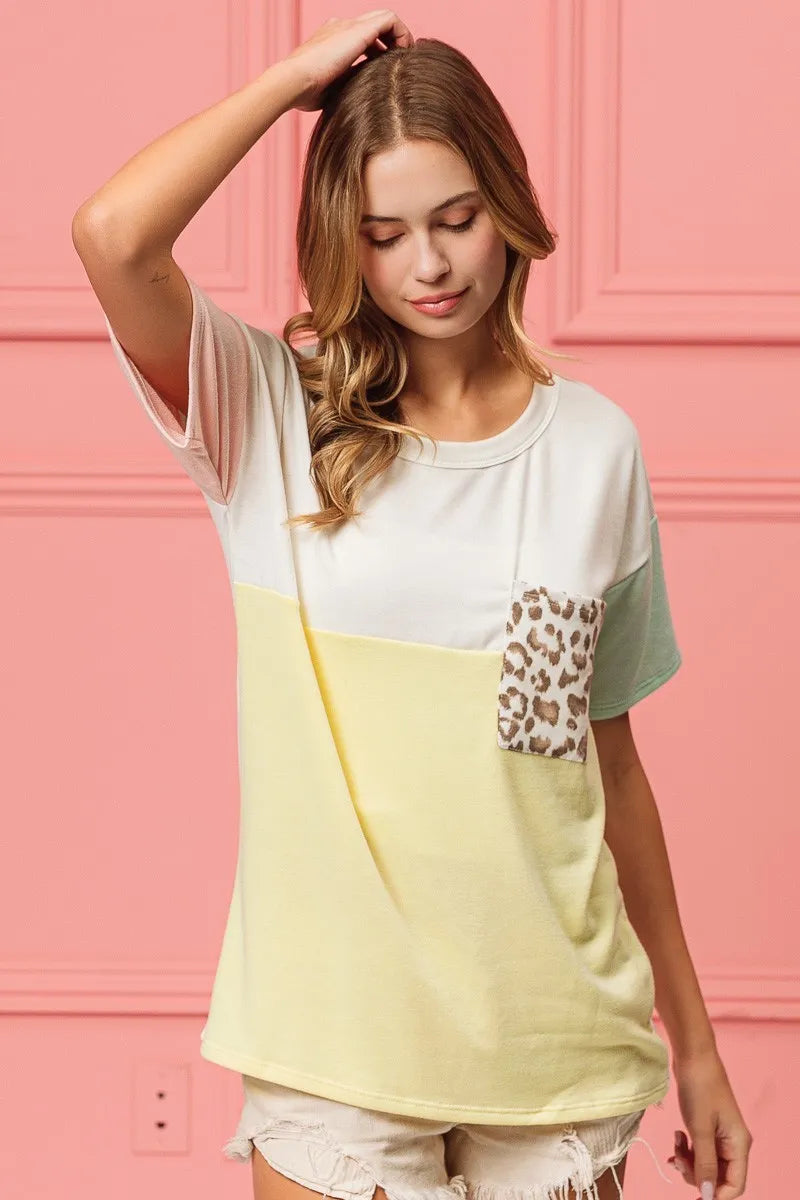 Color-block crew-neck top with leopard front pocket; white and mint sleeves, yellow body