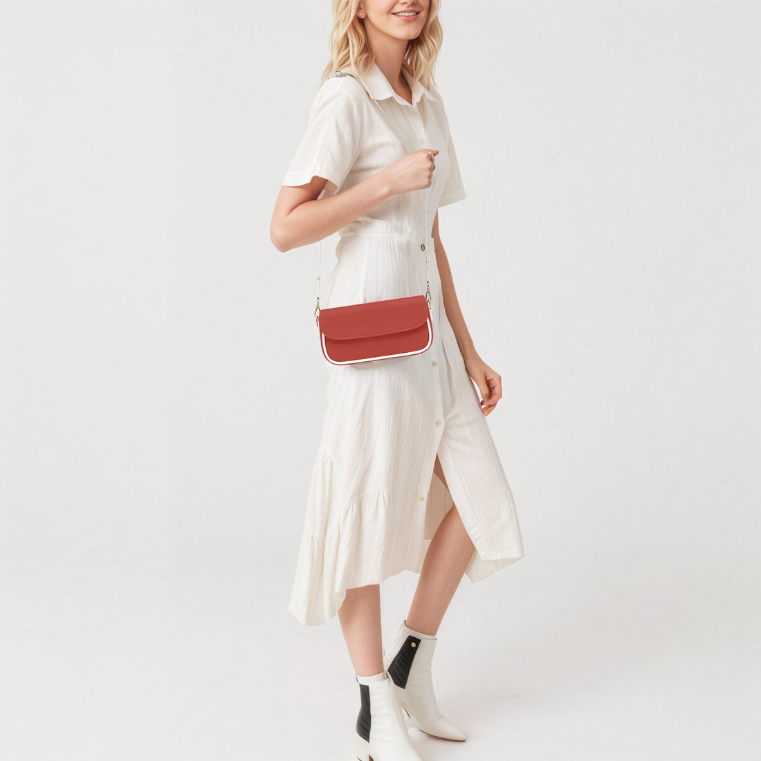 Red leather shoulder bag on a model, front flap and gold chain strap