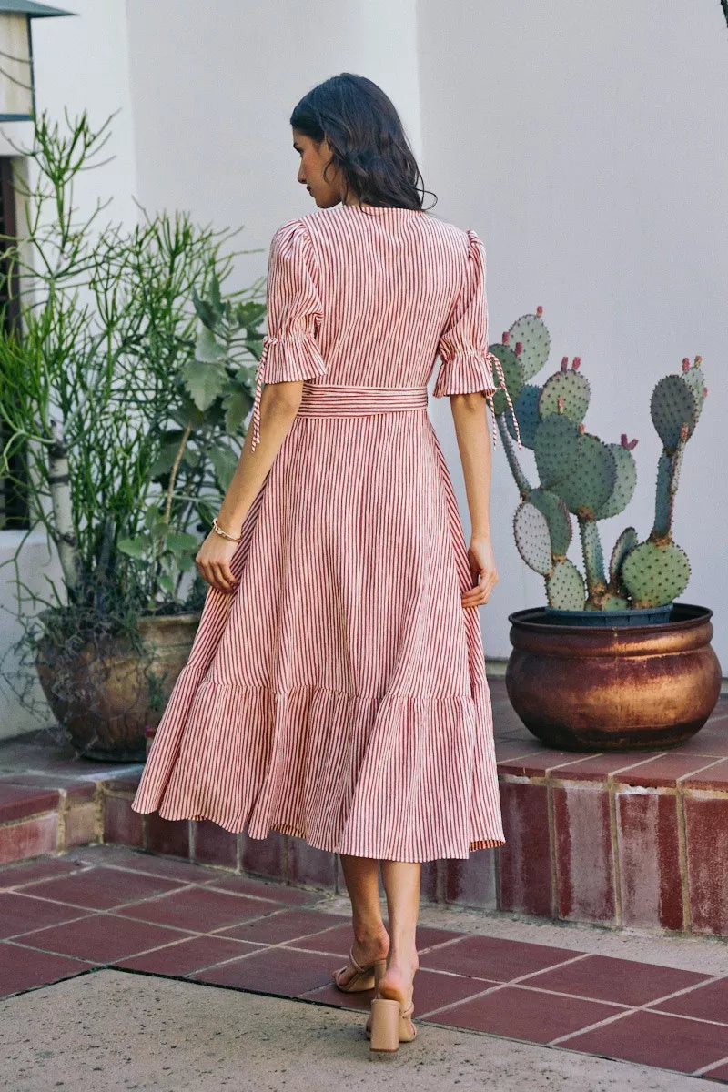 Back view of red-and-white striped wrap midi dress with tied waist and short puff sleeves