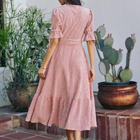 Back view of red-and-white striped wrap midi dress with tied waist and short puff sleeves