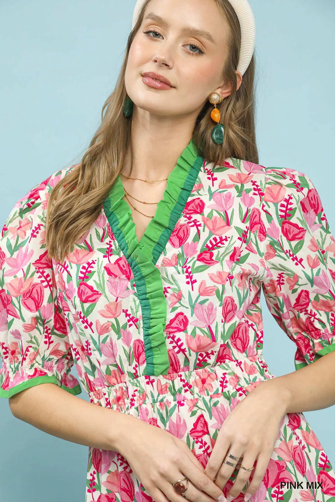 Floral ruffle-trim dress close-up: pink mix with green V-neck and puff sleeves