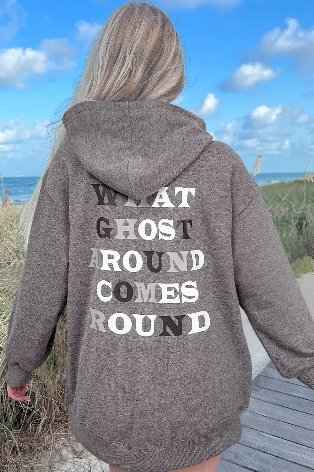 Dark gray oversize hoodie with back text "WHAT GHOST AROUND COMES ROUND" and hood