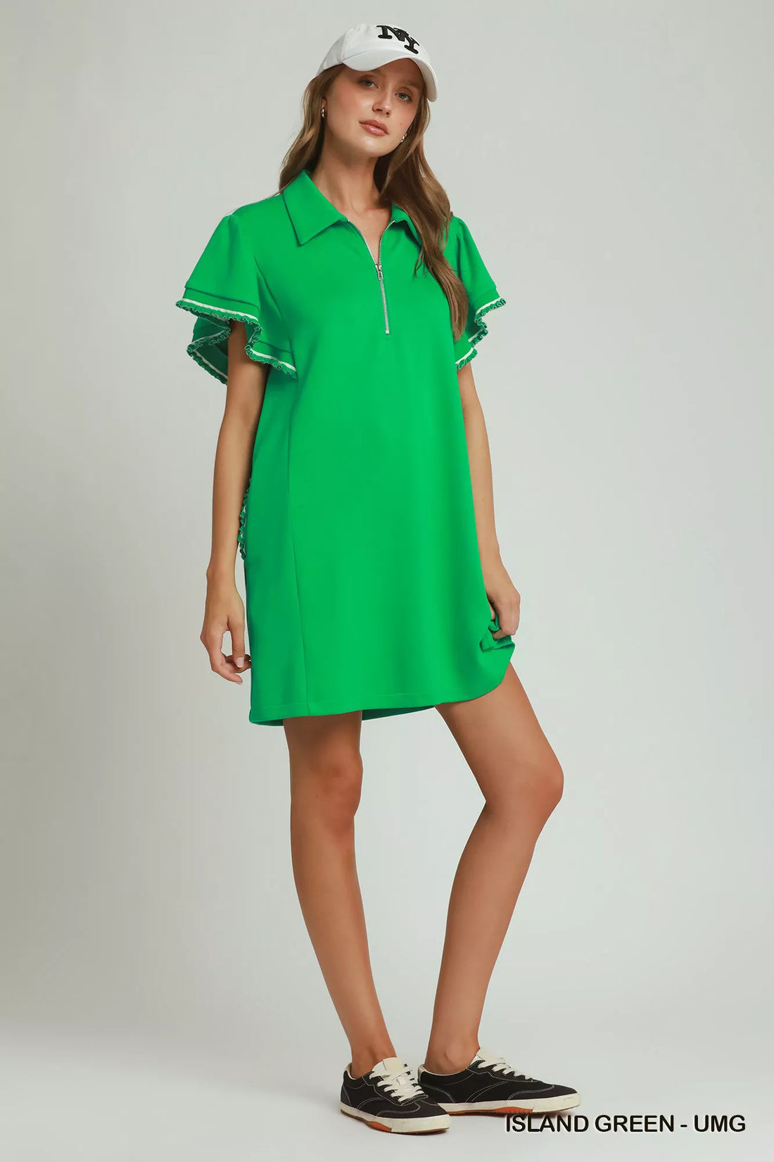 Green mini dress with short half-zip neckline, flutter sleeves, and casual pocket styling