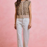White mid-rise wide-leg jeans with ruffled hem and button front