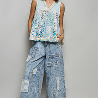 Light blue sheer floral V-neck lace-trim tank with tiered hem and eyelet texture.