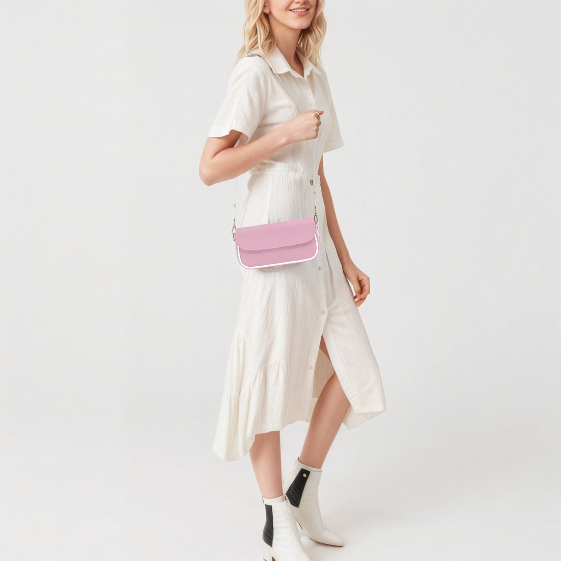 Pastel pink mini shoulder bag on a model, with flap front and chain strap