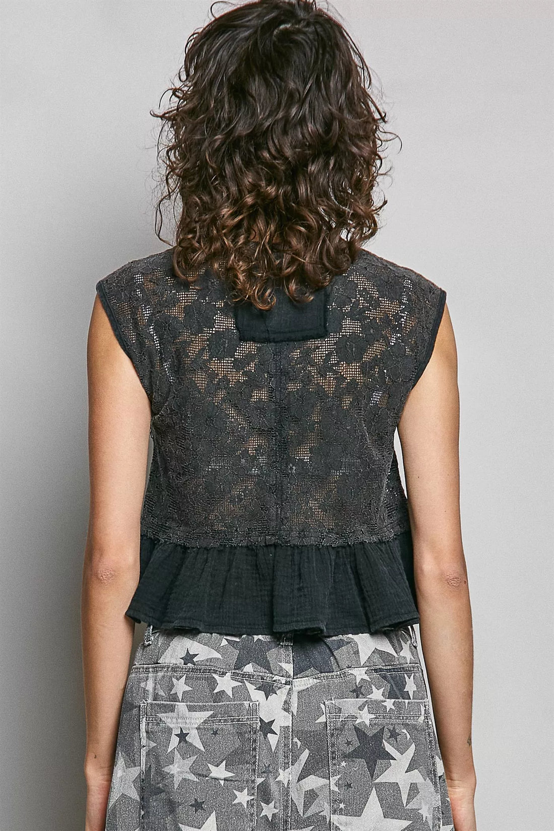 Black lace sleeveless peplum top with round back and ruffled hem