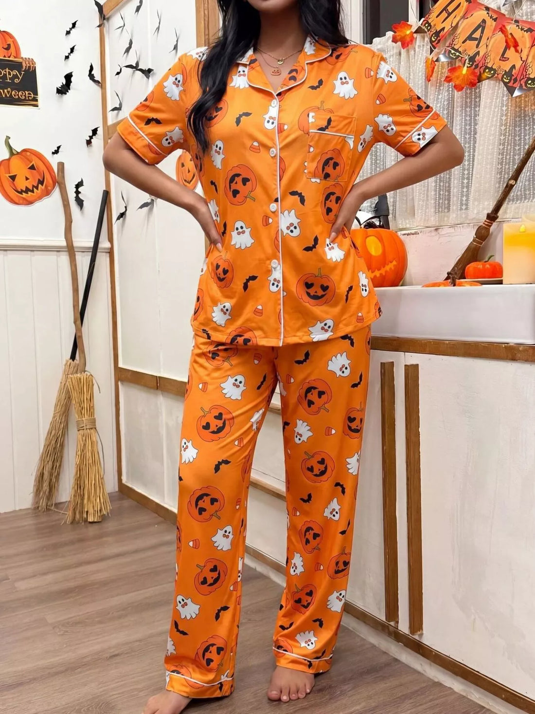 Halloween pajama set: orange short-sleeve button-up top and pants with jack-o&