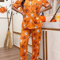 Halloween pajama set: orange short-sleeve button-up top and pants with jack-o'-lantern prints