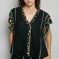 Black V-neck ruffle-sleeve blouse with floral border and pintuck front panels