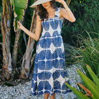 Smocked bodice tiered midi dress with navy and white abstract print, sleeveless