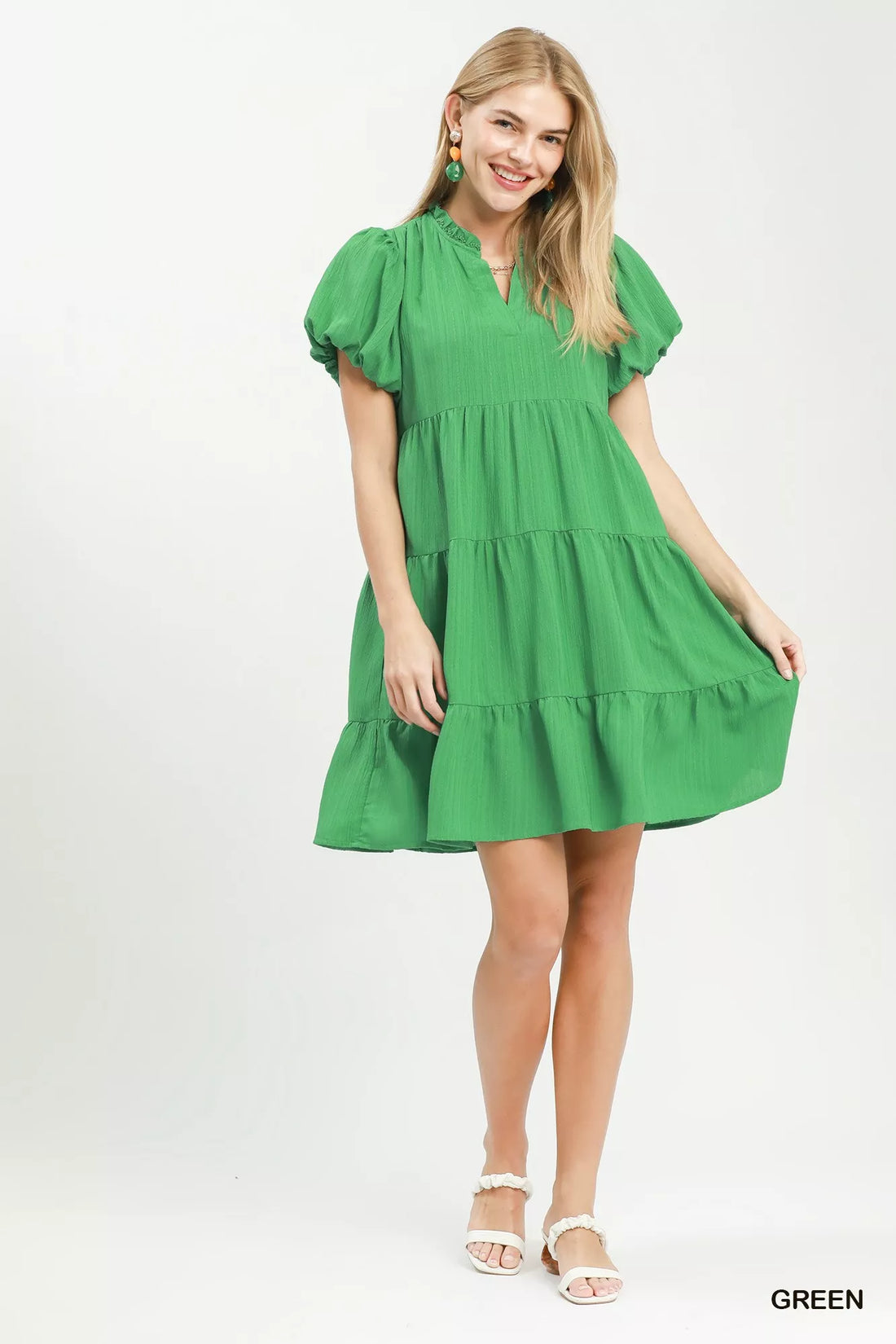 Green tiered babydoll dress with flutter puff sleeves and tiered skirt