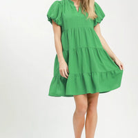 Green tiered babydoll dress with flutter puff sleeves and tiered skirt