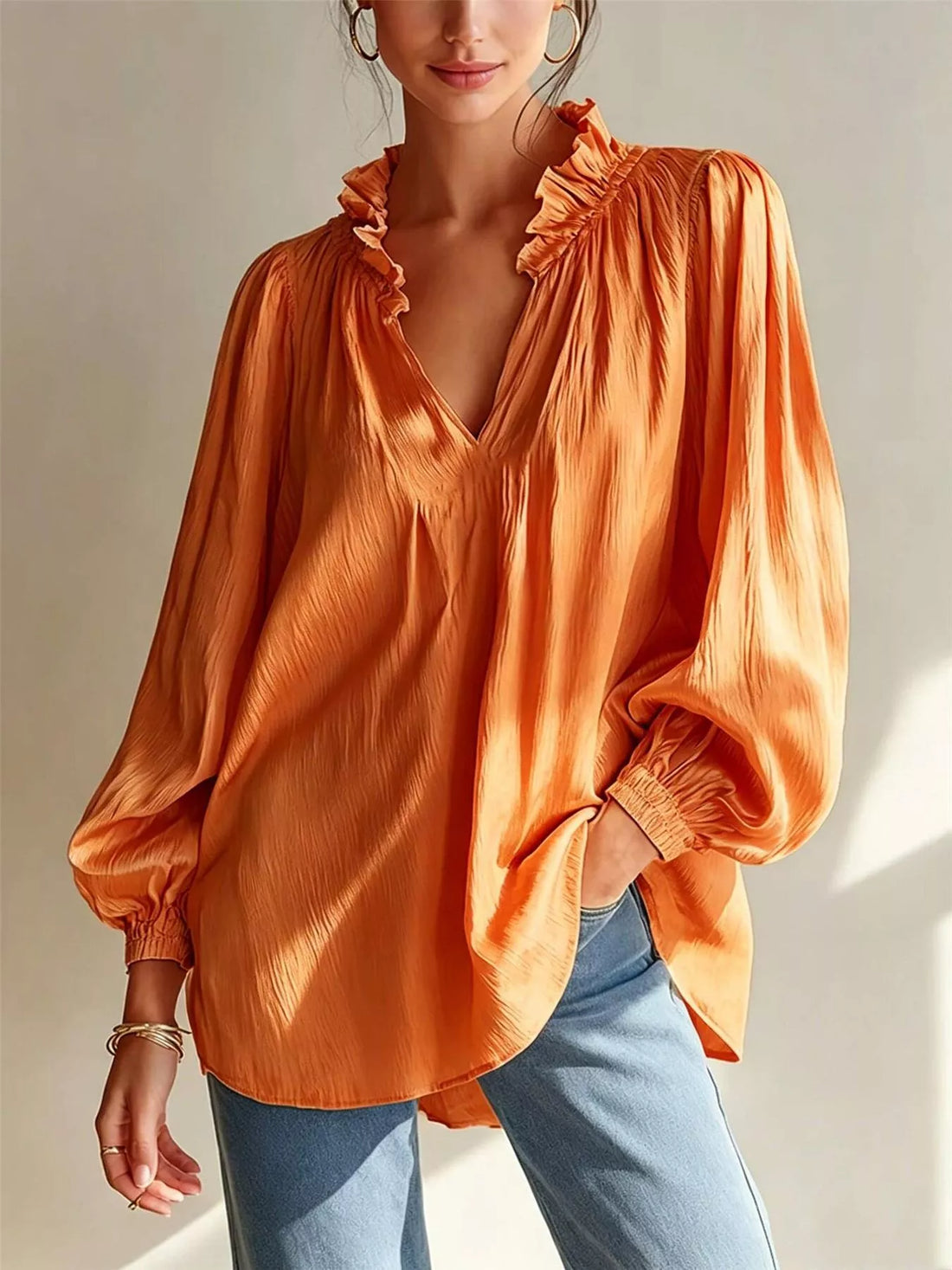 Tangerine ruffle-trim long-sleeve blouse with V-neck and gathered shoulder ruffles