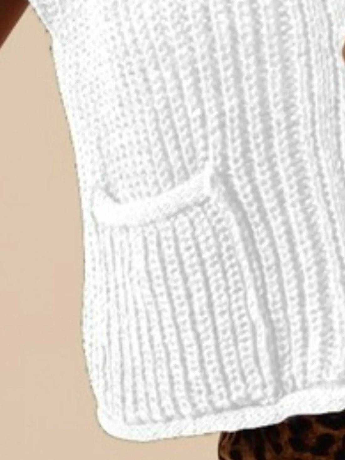 Off-white knit sweater vest detail, textured ribbed fabric and curved hem