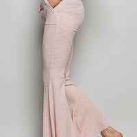 Blush pink textured knit drawstring pants with flared hems and side pockets