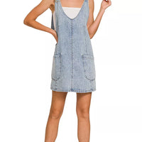 Light wash denim overall dress with adjustable straps and two front pockets