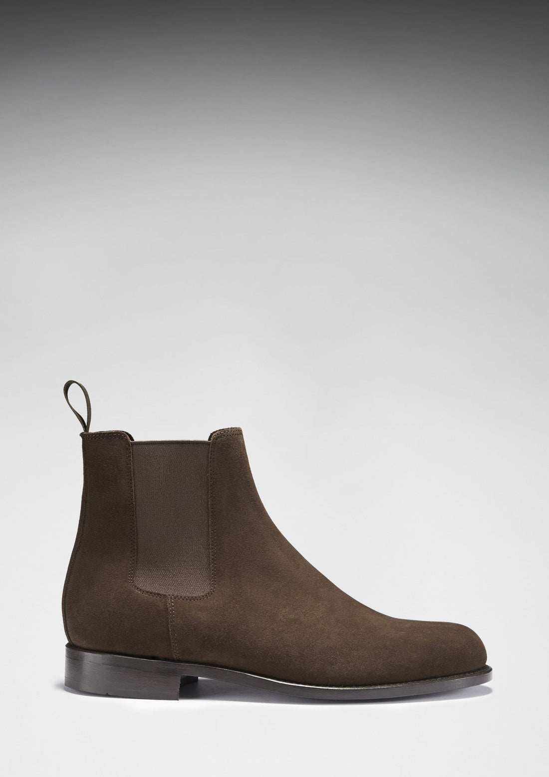 Brown suede Chelsea boot in side profile with a low heel