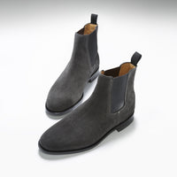 Pair of dark gray suede Chelsea boots with elastic panels and pull tabs