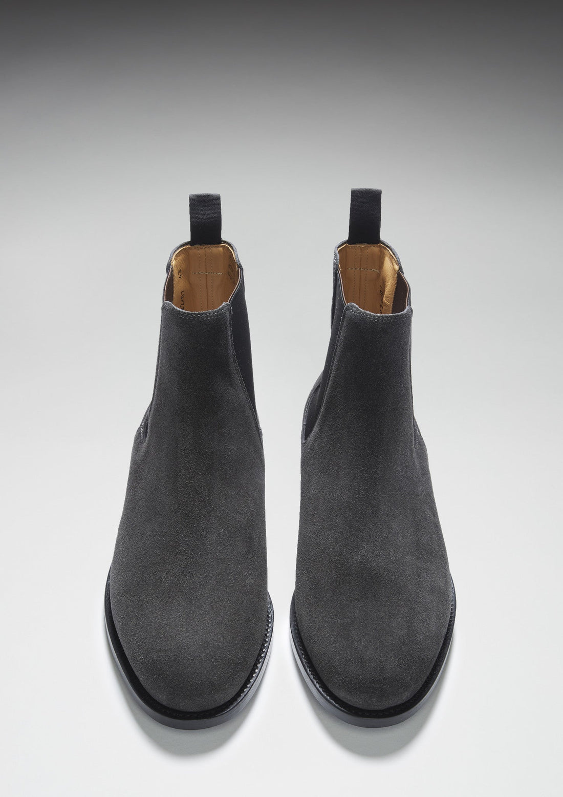 Pair of gray suede Chelsea boots shown from the front