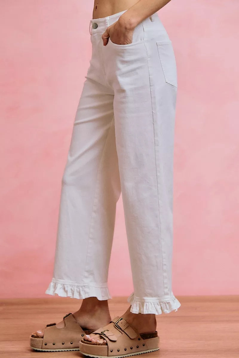 White mid-rise wide-leg jeans with ruffled cuffs and side pockets