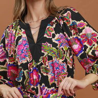Black abstract print belted midi dress detail: V-neck with colorful pattern and gathered waist