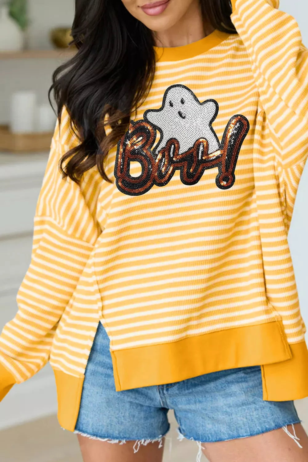 Gold and white striped long-sleeve top with sequin ghost “Boo!” and split hem