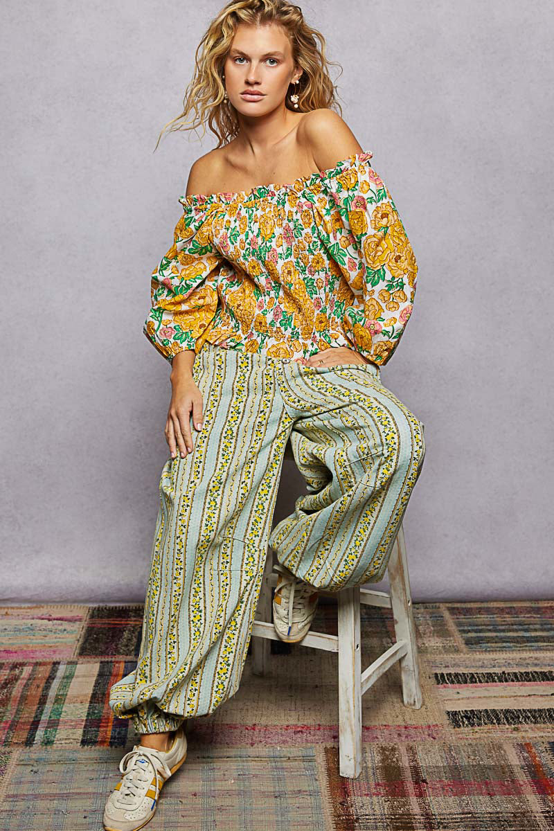 Floral off-shoulder smocked blouse with wide elastic neckline and long puff sleeves