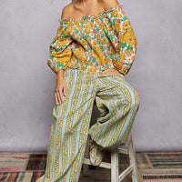Floral off-shoulder smocked blouse with wide elastic neckline and long puff sleeves