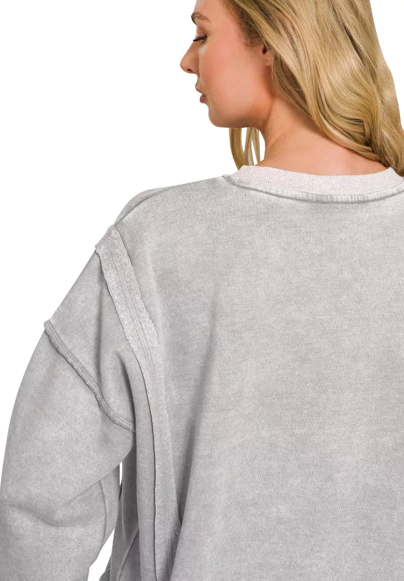Back view of gray acid-washed fleece pullover with contrast shoulder seam