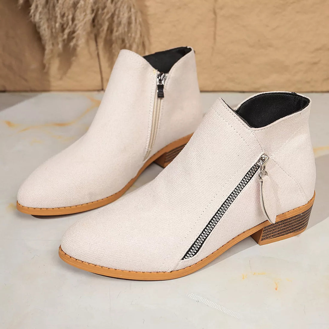 Light beige point-toe block heeled ankle boots with side zipper and tan block heel