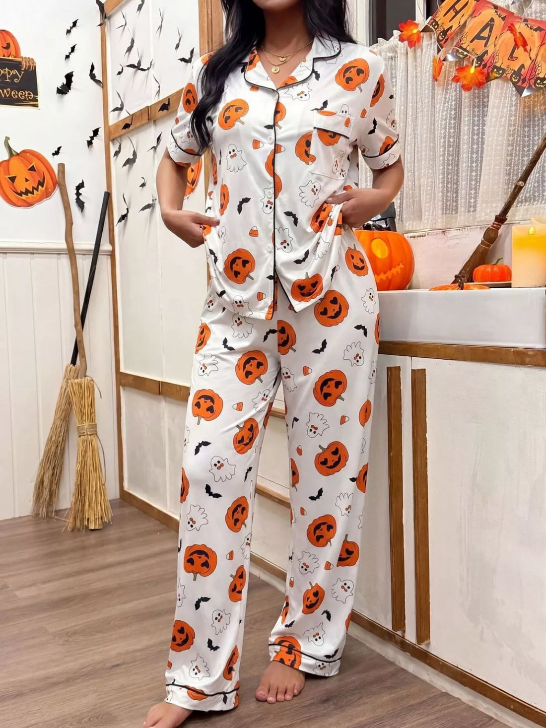 Halloween pajama set: white short-sleeve button-up top and pants with pumpkin prints