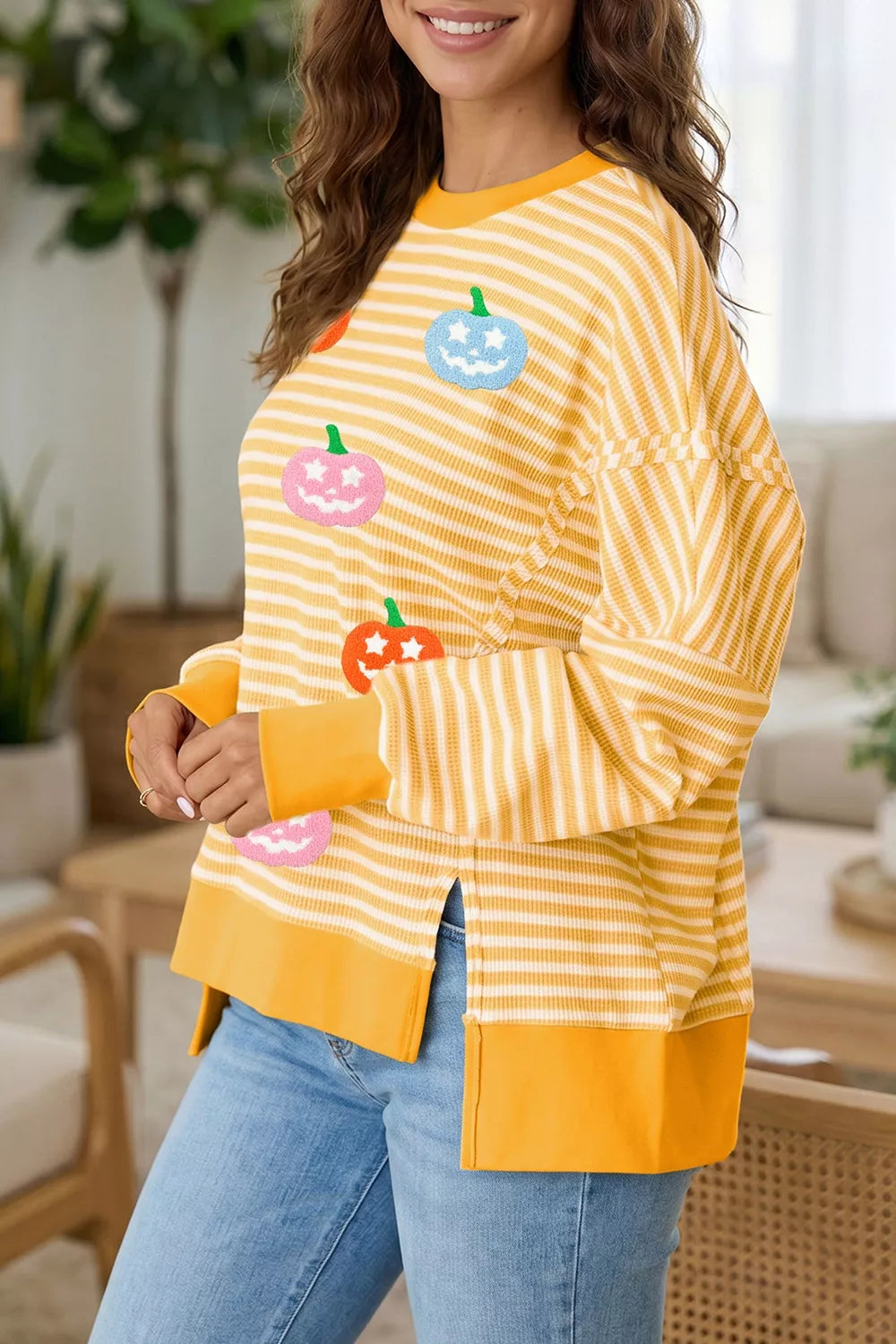 Yellow striped Halloween waffle-knit pullover with pumpkin graphic and side slits